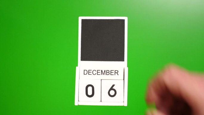 日历上的日期12月6日在绿色的背景。说明某一特定日期的事件。