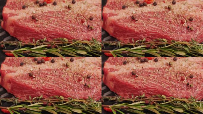 新鲜的大理石牛肉与胡椒，盐和迷迭香特写特写。准备烤多汁的牛排。优质有机生和牛肉
