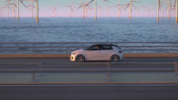 通用电动汽车行驶在一座桥上，背景是风力涡轮机