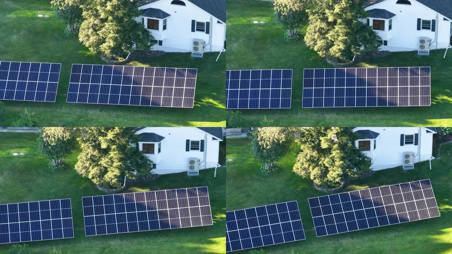 太阳能光伏板安装在后院地面上的独立框架上的自主房屋，产生清洁的生态电能