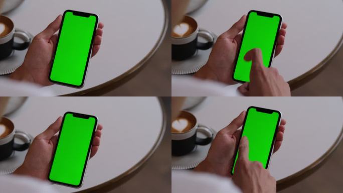 在咖啡馆里点击和滑动绿屏智能手机