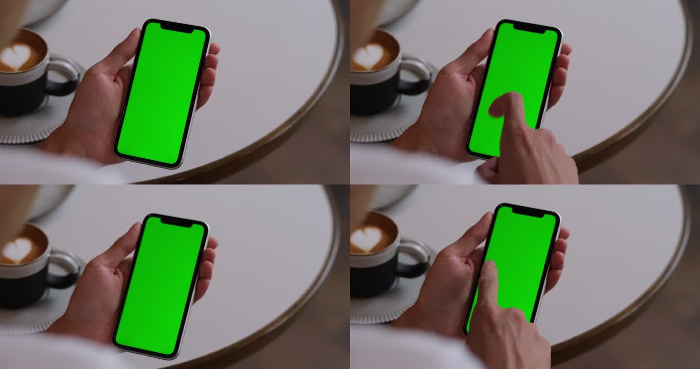 在咖啡馆里点击和滑动绿屏智能手机