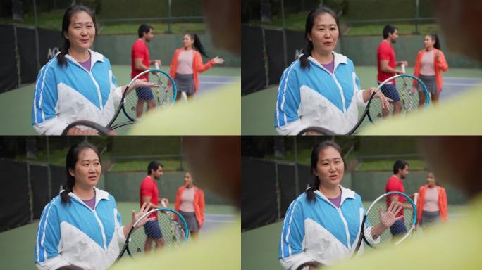 一个成熟的女人在网球场上和同事搭讪