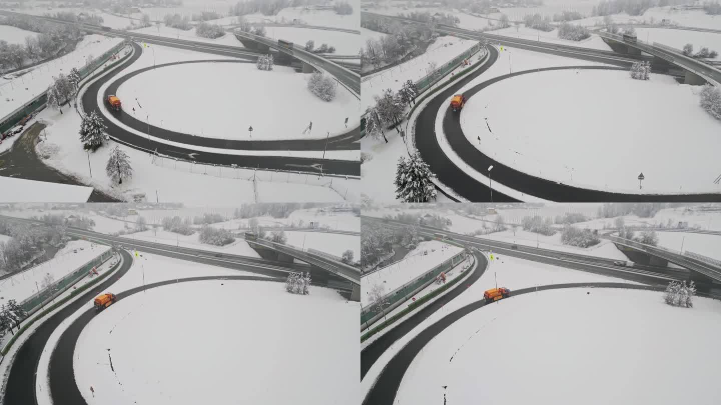 橙色扫雪车在高速公路上行驶的鸟瞰图