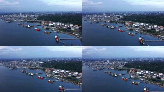 背景是停靠的油轮和印尼国家石油公司(Pertamina)炼油厂的上升视图——印尼巴厘巴班市港口