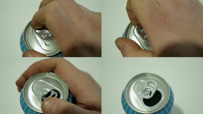 特写:男性右手打开铝制饮料罐上的拉环