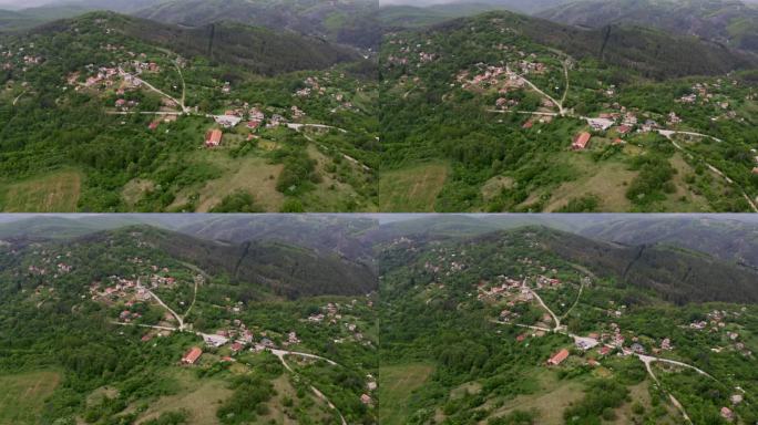 无人机从画面的左到右平移，捕捉到保加利亚偏远地区Tsarichina Hole村的风景。