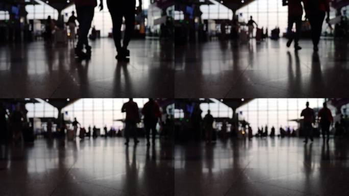 现代机场出发楼的模糊景象，过往人群的剪影