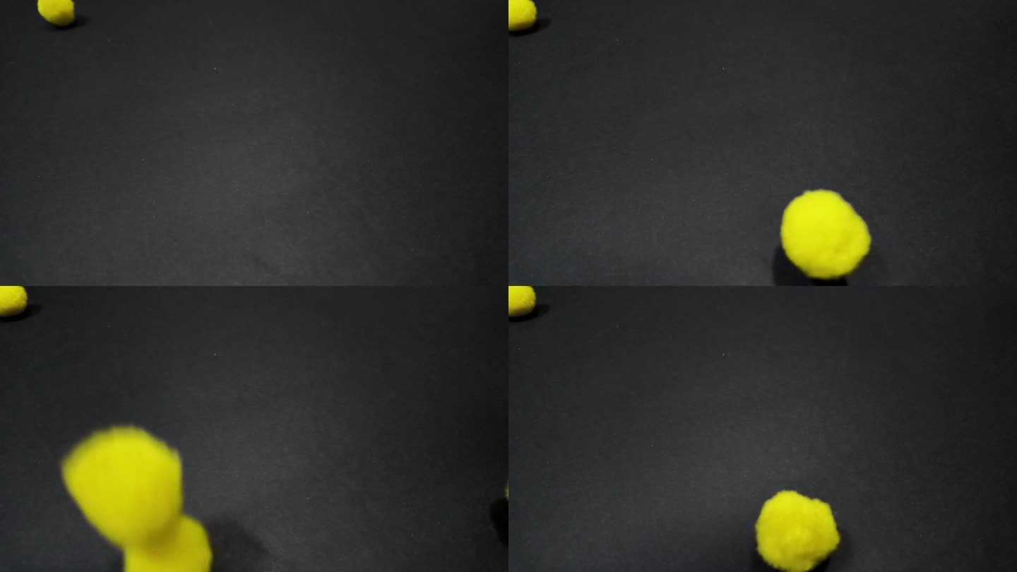 黄色的绒球落在黑色的背景上。