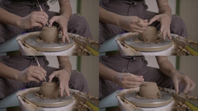 手在纺车上塑造陶器的特写，关注创作过程