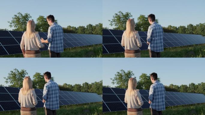 在一个小型家用太阳能发电厂，两个人正在谈论太阳能电池板。生态清洁发电