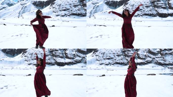 印度女孩在印度拉胡尔的雪山前享受的慢镜头。在寒冷晴朗的日子里，山里的女孩。双臂高举的女孩。冬天的假期