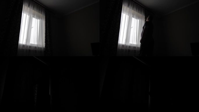 那人拉上深色的窗帘，不让光线照进房间。