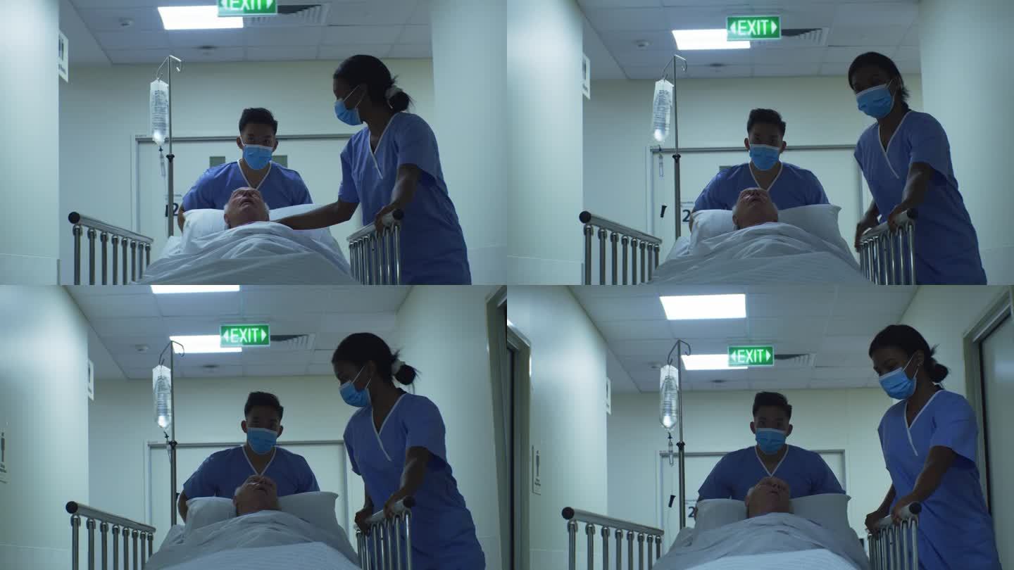 两名护士在医院把一位老人带到他的房间
