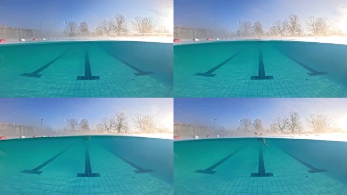 运动女子在旅游胜地泳池练习自由泳的部分水下锁定镜头