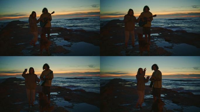 无忧无虑的青少年剪影放松早晨的海边。夫妇和可爱的狗
