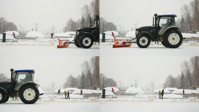 公共设施正在与积雪作斗争。气象观测史上最大的降雪。巨大的三辆拖拉机和后面拿着铁锹的人