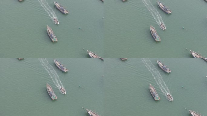 航拍俯瞰威海双岛湾海面航行的快艇渔船