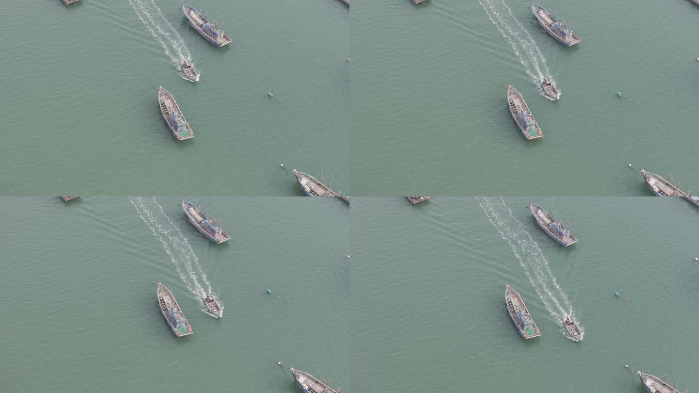航拍俯瞰威海双岛湾海面航行的快艇渔船