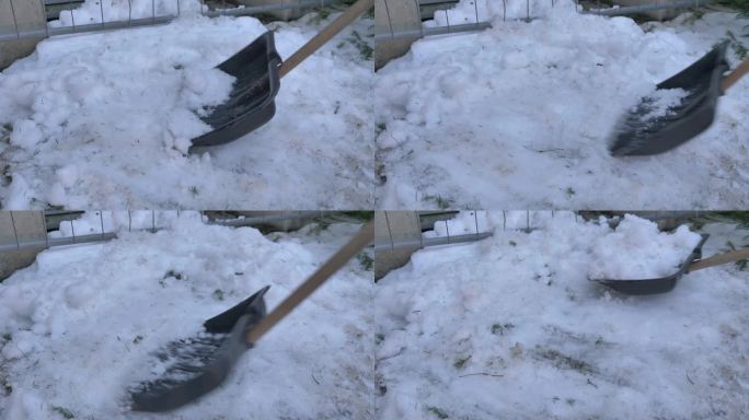 工人用铲子清理街道上的积雪
