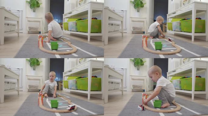 可爱的小男孩在玩木制铁路玩具，小朋友在房间的地板上玩电动火车玩具