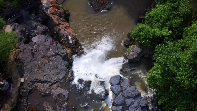 从上到下，水在印度尼西亚巴厘岛的Tegenungan瀑布汇入天然水池