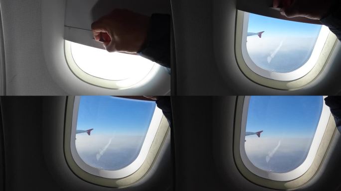 商用客机在飞行途中，双手打开窗户，欣赏蓝天