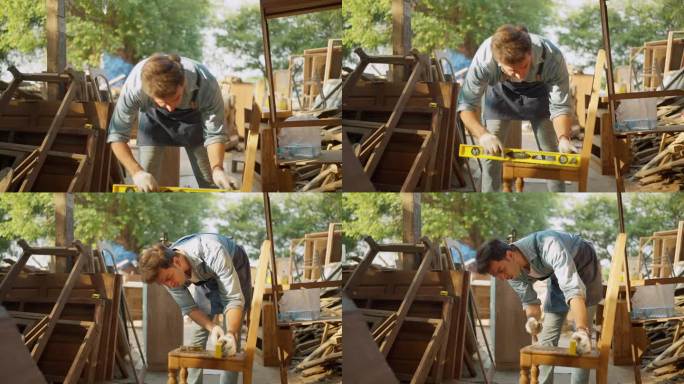 一位男木匠在木工车间用精密水平仪制作新家具。木匠用精密的木器制作家具。木匠和木制品的概念