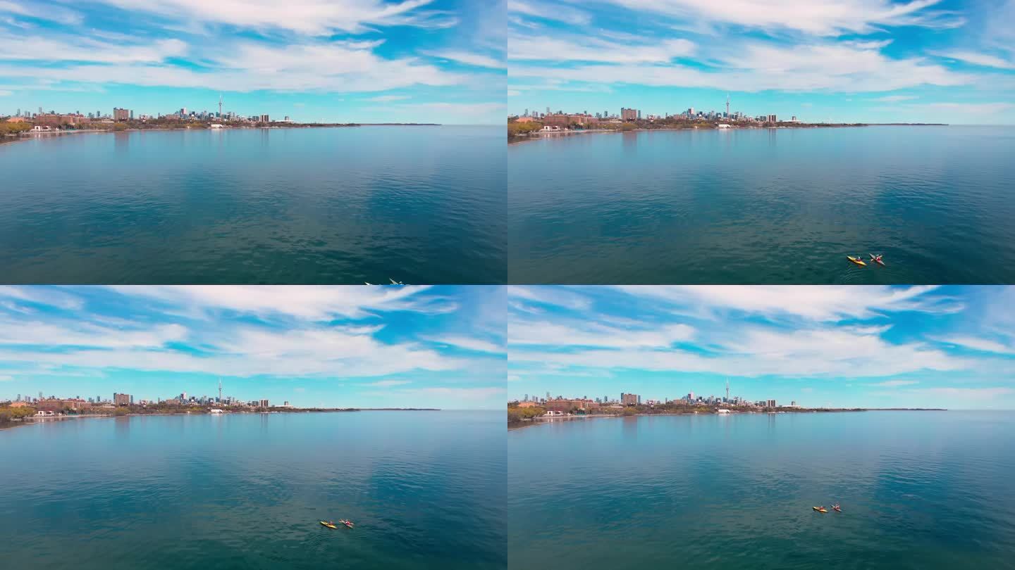 皮划艇者划桨湖北美城市背景，完美的活跃休闲。积极休闲的缩影。拥抱积极休闲的城市景观景观，城市冒险。水
