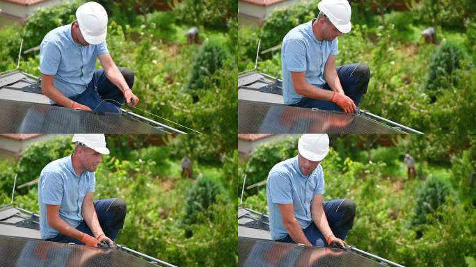 在屋顶上建造光伏太阳能系统时，工人正在观察太阳能组件的均匀度。