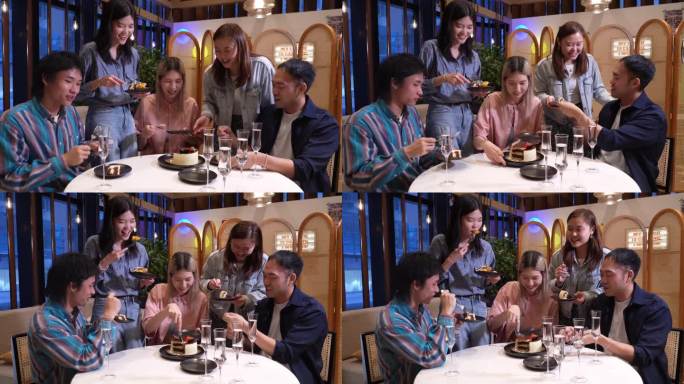 年轻的亚洲女子和她的朋友们一起在咖啡馆里吃着食物和咖啡庆祝。
