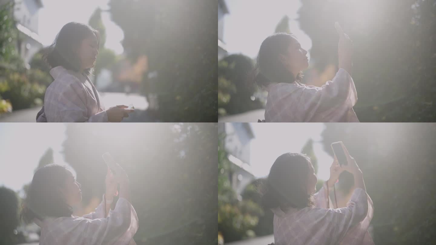 秋天，身穿和服的微笑女子在浅草寺用智能手机拍摄照片和视频。