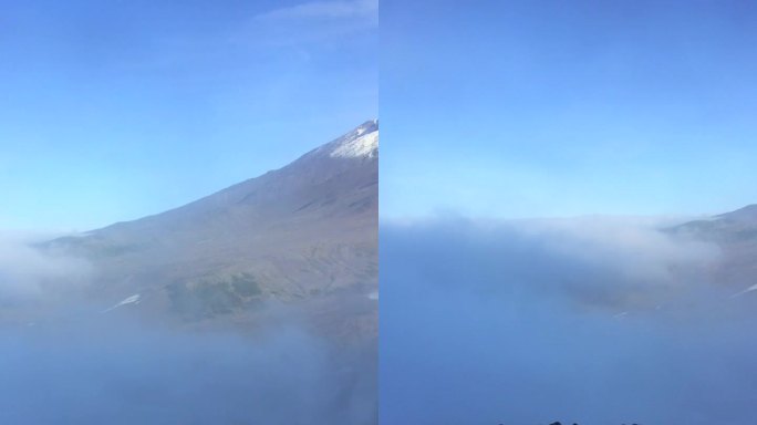 Koryaksky火山的峰顶在云层上升起