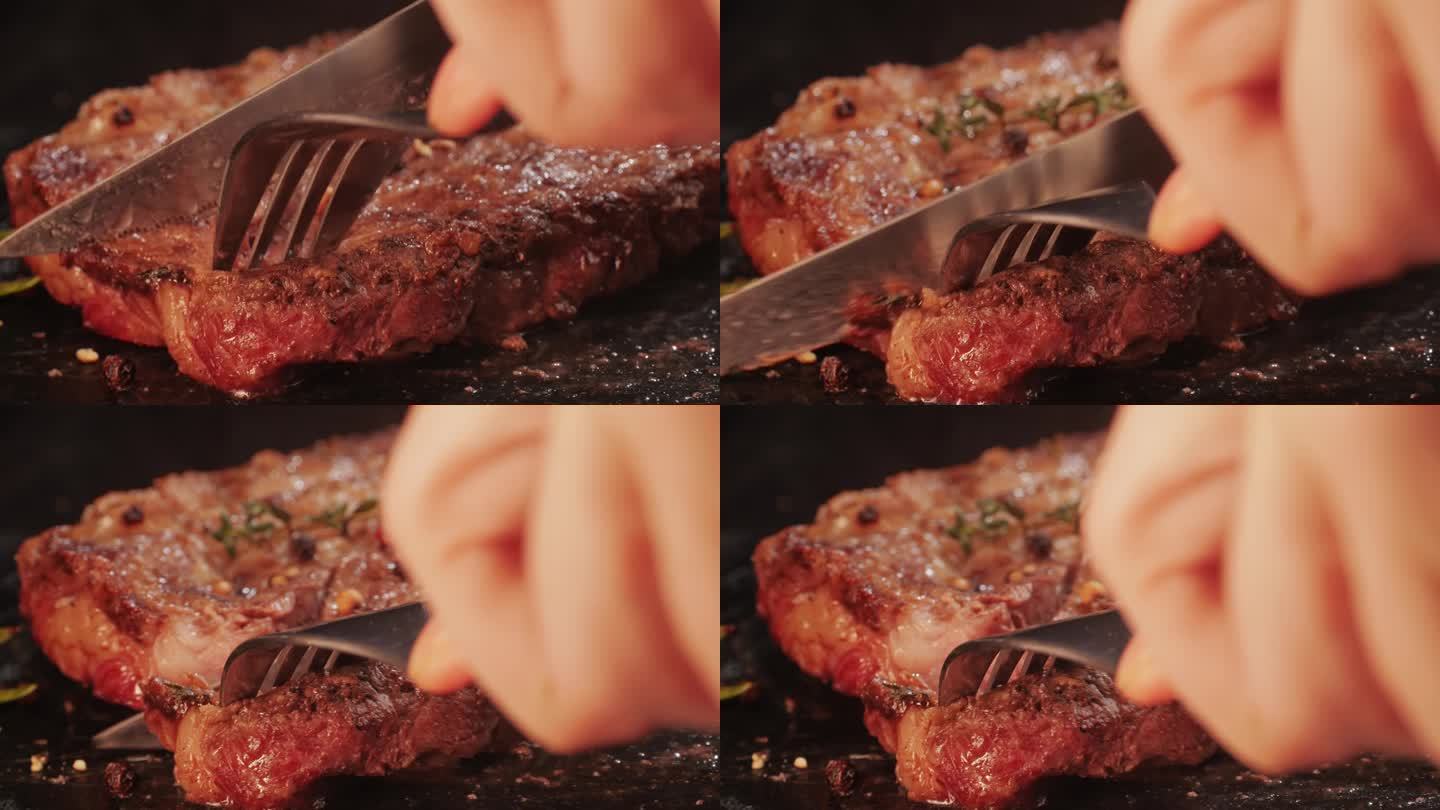 新鲜的大理石牛肉与胡椒，盐和迷迭香特写特写。用刀切多汁的牛排放在盘子里。优质有机和牛肉