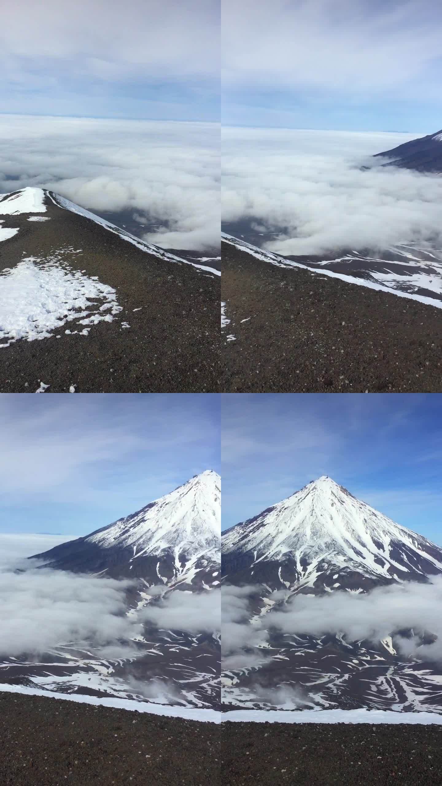 Koryaksky火山的峰顶在云层上升起