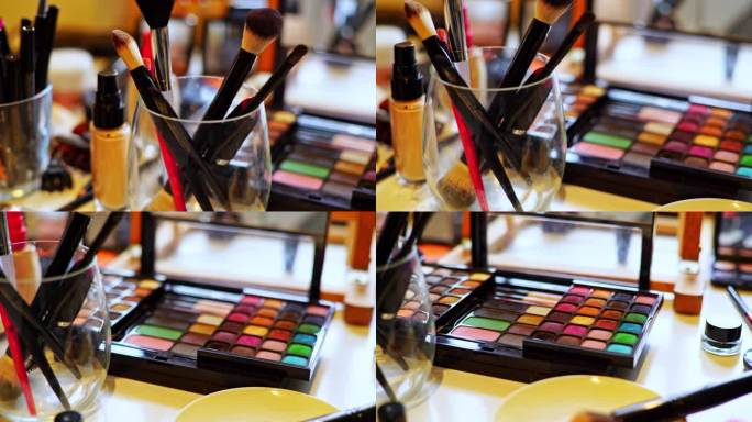 一套化妆刷，美容产品和眼影盘排列在美容院的桌子上
