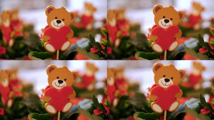 情人节快乐。特写镜头。木制玩具泰迪熊，红色的心在一个花盆里的花。礼物，作为感情和爱的表达。情人节的节