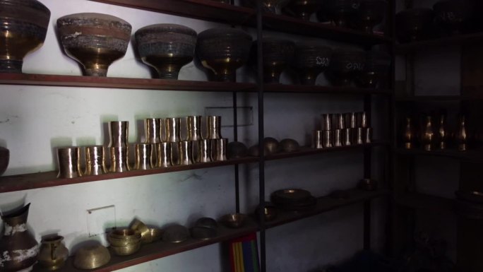 铜黄铜器具陈列在木制橱柜里。