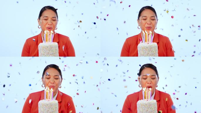 女人，蛋糕和吹蜡烛在工作室，五彩纸屑和生日庆祝与微笑的蓝色背景。亚洲女孩，派对或活动与甜点，火焰和快