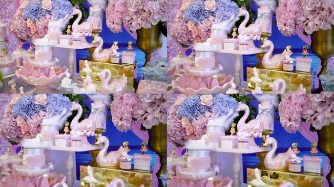 生日派对上的糖果桌，有插花、粉红天鹅和装饰芭蕾舞演员