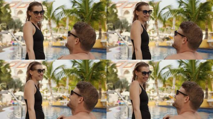 一对幸福的年轻夫妇在度假酒店的游泳池边放松。暑假，浪漫之旅