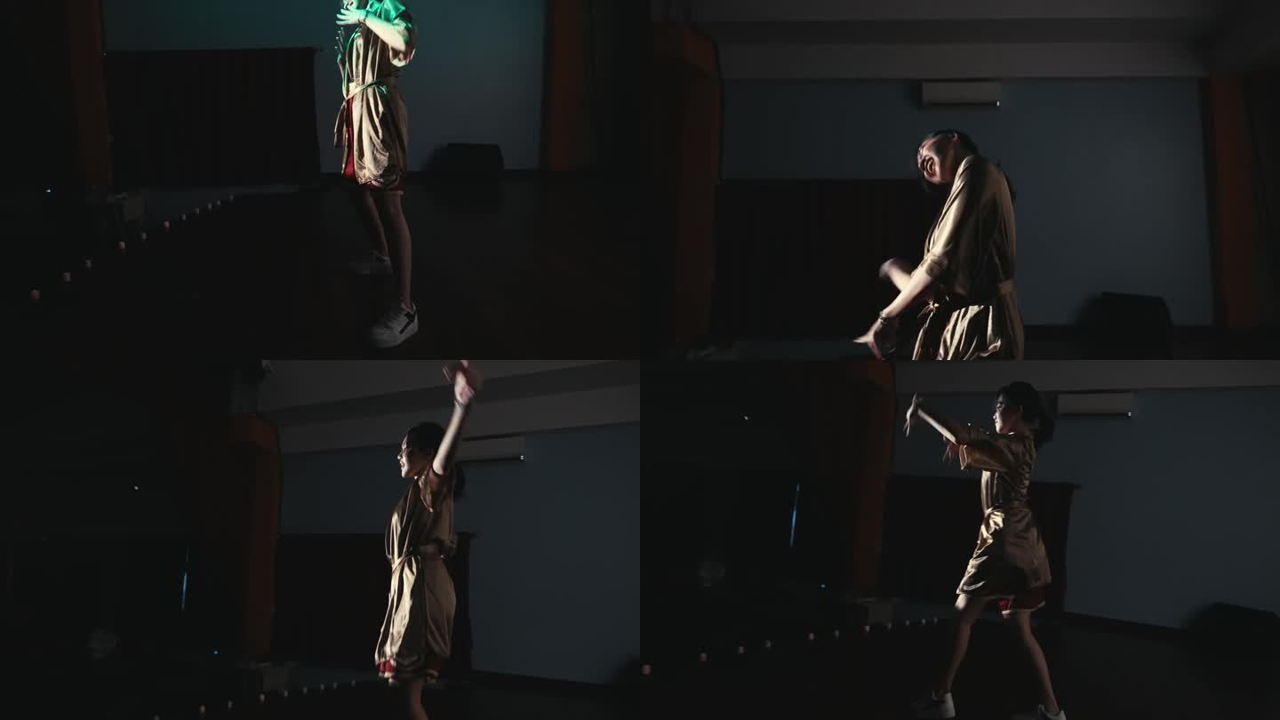 一个女舞者的剪影，在黑暗的舞台上表演着富有表现力的手势，灯光变幻莫测。