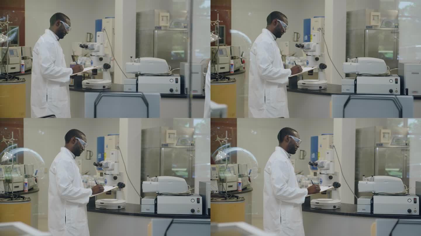 男科学家在实验室工作时做笔记