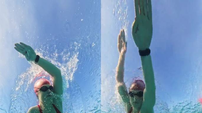 在阳光明媚的日子里，坚定的年轻女子在泳池里练习爬泳的水下镜头