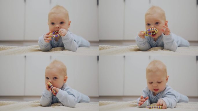 婴儿出牙。一个孩子在玩出牙玩具。小男孩用牙齿抓他的牙龈。可爱的小男孩第一次长牙。幼儿期的儿童发展。