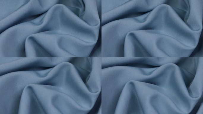蓝色的织物。布。蓝色布料波浪背景纹理。
