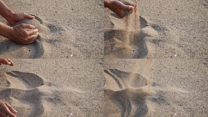近距离的手释放掉落的沙子。沙子流过双手拍打着海洋