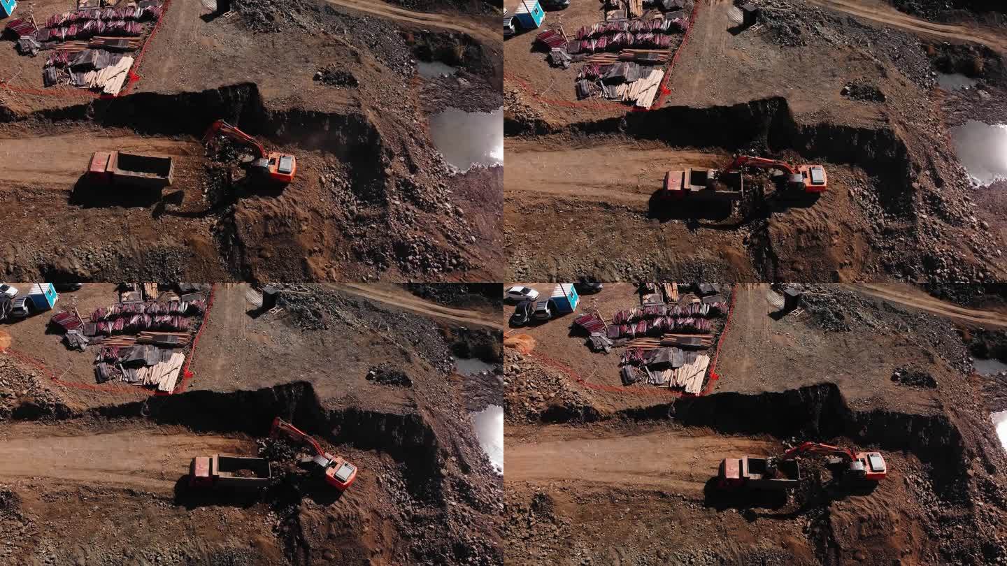 挖掘机装载自卸卡车与地面上的施工现场由无人机拍摄