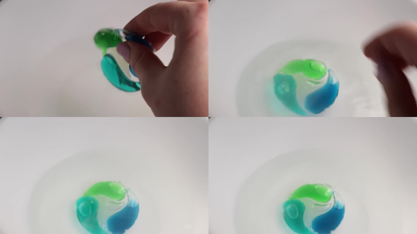 洗涤凝胶胶囊豆荚用洗衣粉扔入水中。蓝绿色洗衣液的全画幅镜头。
