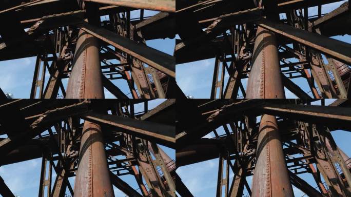旧工业结构的复杂，生锈的外观，以纵横交错的金属梁包围的大型圆柱形管道为特色